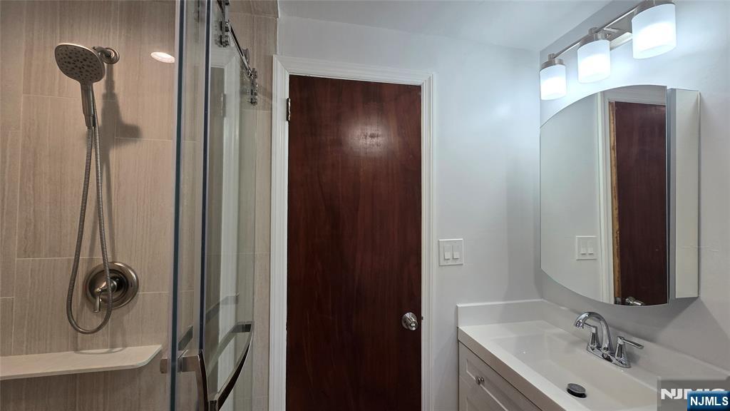 459 Summit Street Ridgewood, NJ 07450 - Photo 18 of 22 a bathroom with a mirror and a sink