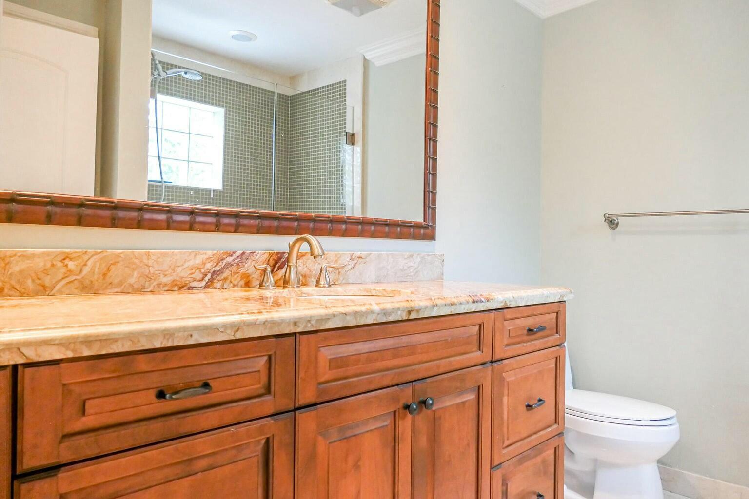 18014 Perigon Way Jupiter, FL 33458 - Photo 16 of 35 a bathroom with a granite countertop sink and a toilet