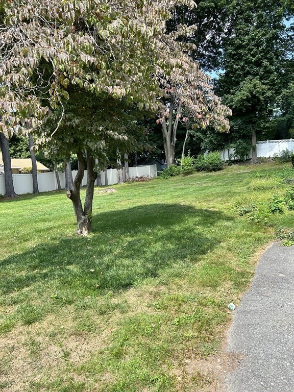 96 MacArthur Road Stoneham, MA 02180 - Photo 2 of 3 a view of green field with trees in the background