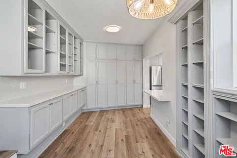 a bathroom with a granite countertop sink mirror vanity and toilet