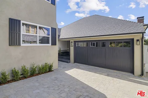 an aerial view of a house with a yard and large trees