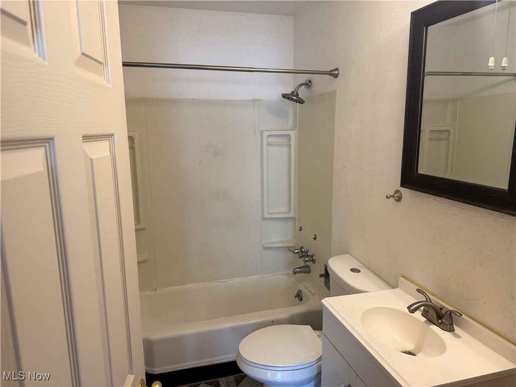 6350 Meadowbrook Road Garfield Heights, OH 44125 - Photo 21 of 28 Full bath with a textured wall, shower / washtub combination, and vanity