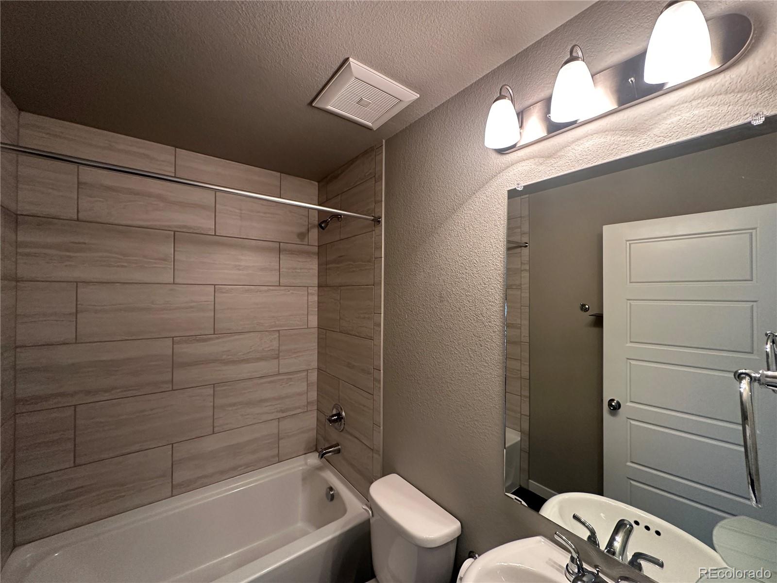 6612 Thicket Pass Lane Colorado Springs, CO 80927 - Photo 12 of 17 a bathroom with a sink and a mirror