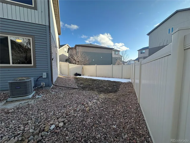 a view of a backyard with a barbeque grill and plants