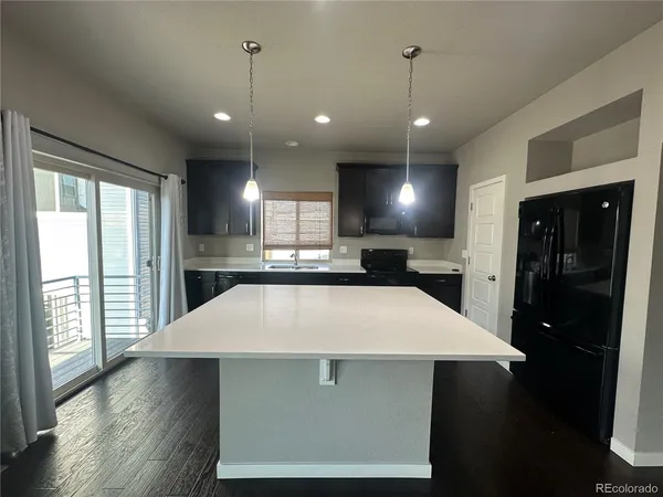 a large kitchen with stainless steel appliances kitchen island a large island in the center