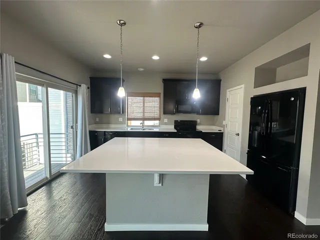 a large kitchen with stainless steel appliances kitchen island a large island in the center