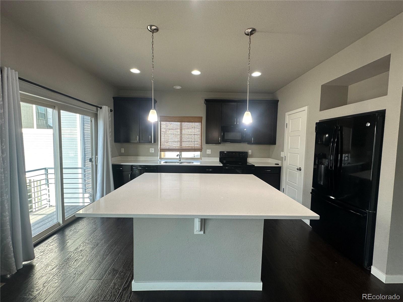 6612 Thicket Pass Lane Colorado Springs, CO 80927 - Photo 4 of 17 a large kitchen with stainless steel appliances kitchen island a large island in the center
