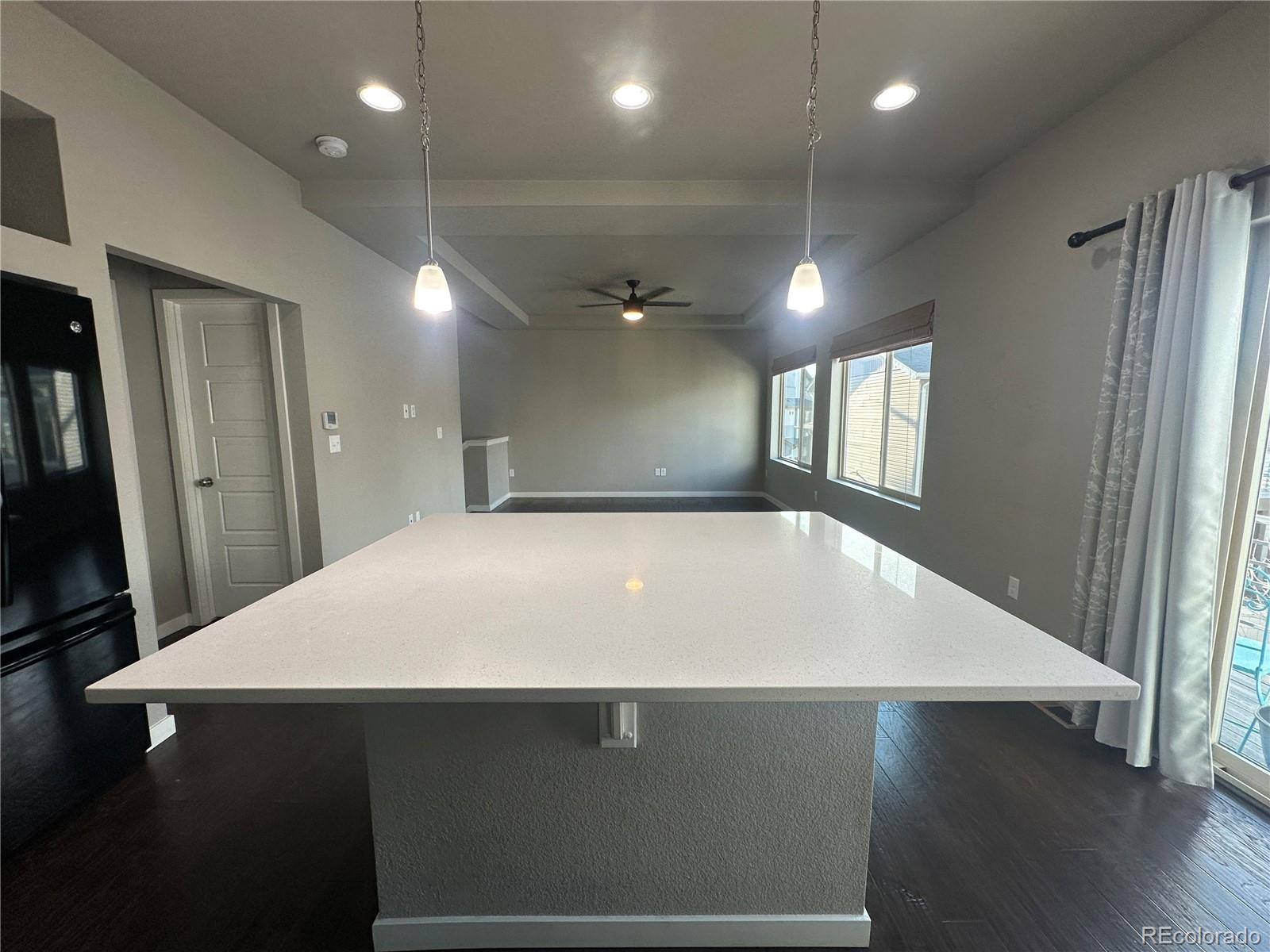 6612 Thicket Pass Lane Colorado Springs, CO 80927 - Photo 7 of 17 a view of an empty room with wooden floor and a window