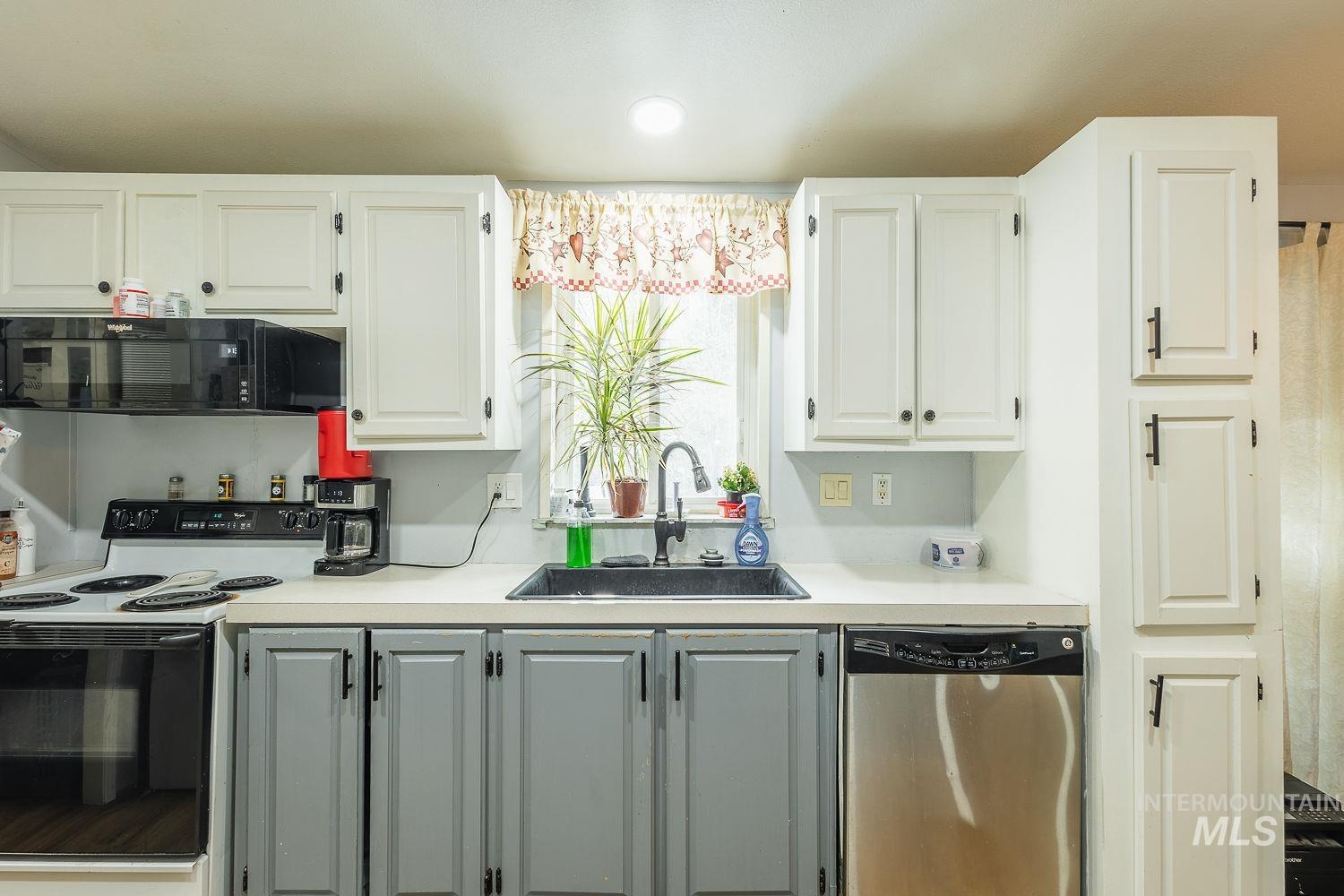 10 Reseda Ridge Circle Garden Valley, ID 83622 - Photo 15 of 28 Kitchen with range with electric stovetop, light countertops, dishwasher, black microwave, and white cabinets