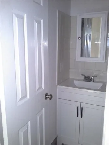 a bathroom with a sink vanity and mirror