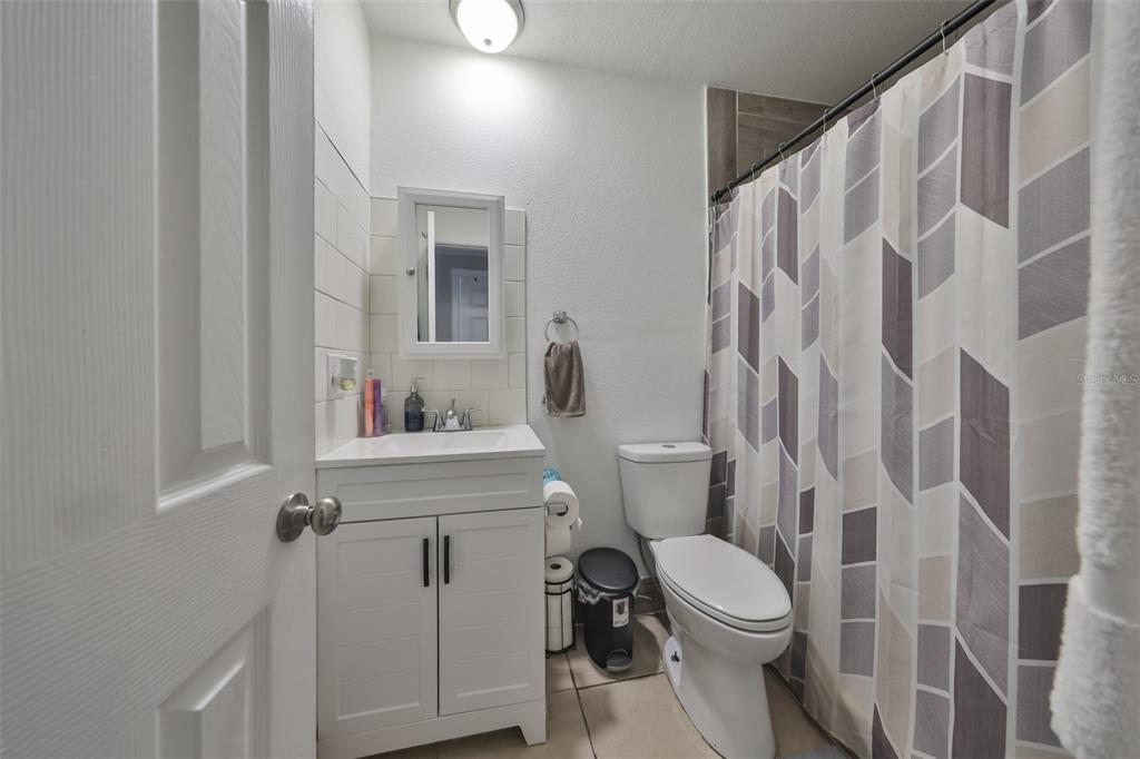 11708 Balm Riverview Road Riverview, FL 33569 - Photo 13 of 38 a white toilet sitting next to a bathroom sink