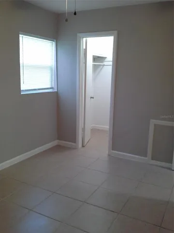 an empty room that has a window in it