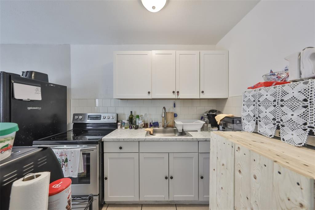 11708 Balm Riverview Road Riverview, FL 33569 - Photo 14 of 38 a kitchen with a sink stove and cabinets