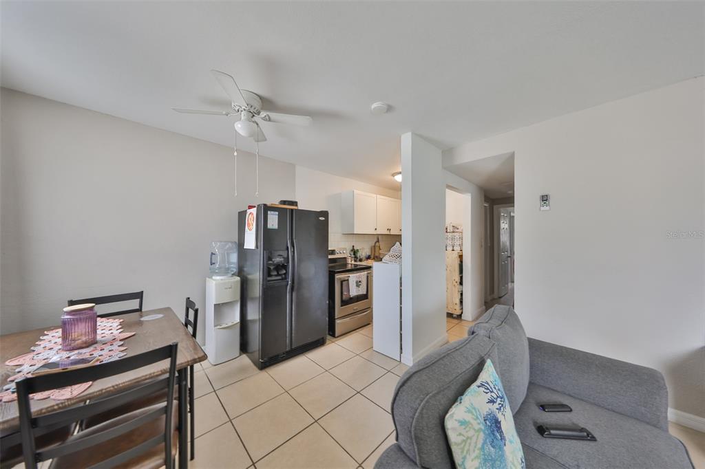 11708 Balm Riverview Road Riverview, FL 33569 - Photo 18 of 38 a kitchen with stainless steel appliances kitchen island granite countertop a refrigerator and a stove top oven
