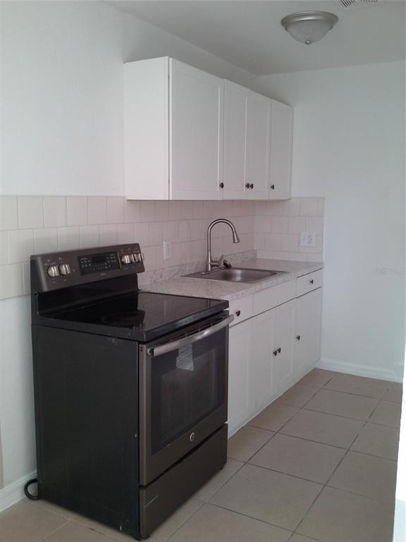 11708 Balm Riverview Road Riverview, FL 33569 - Photo 18 of 19 a white stove top oven sitting inside of a kitchen