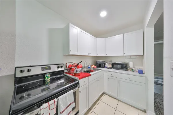 a kitchen with a sink cabinets and appliances