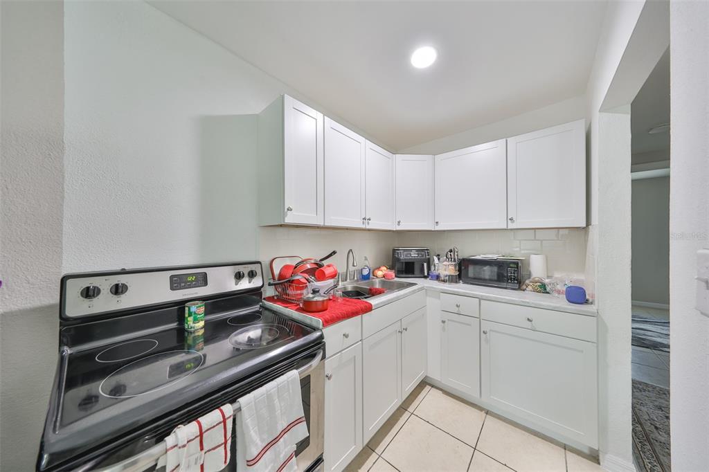 11708 Balm Riverview Road Riverview, FL 33569 - Photo 5 of 38 a kitchen with a sink cabinets and appliances