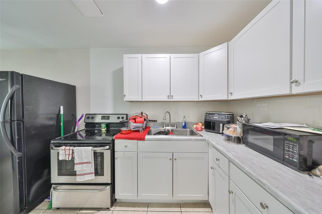 11708 Balm Riverview Road Riverview, FL 33569 - Photo 6 of 38 a kitchen with stainless steel appliances granite countertop a sink stove and refrigerator