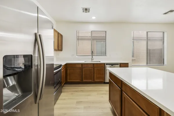 a kitchen with a sink stove and refrigerator