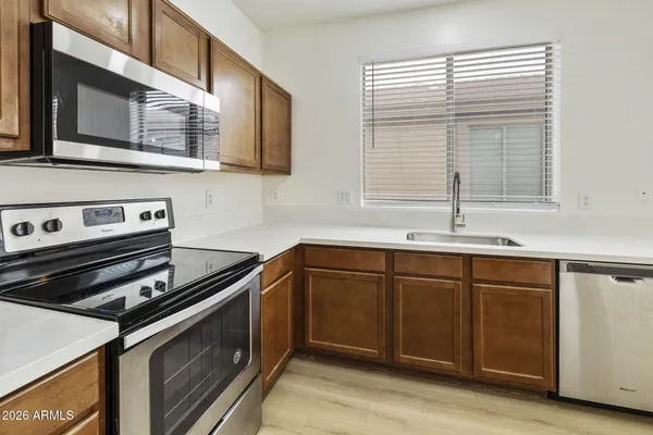 a kitchen with stainless steel appliances granite countertop a stove and a sink