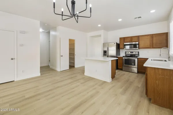 a kitchen with stainless steel appliances granite countertop a refrigerator and a stove top oven