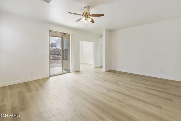 wooden floor in an empty room with a window
