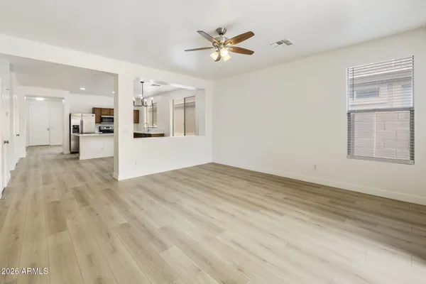 a view of a room with wooden floor and a bathroom