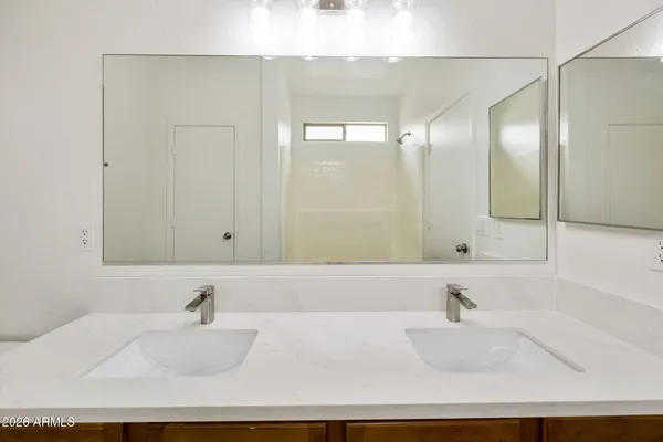 a bathroom with a tub sink and mirror