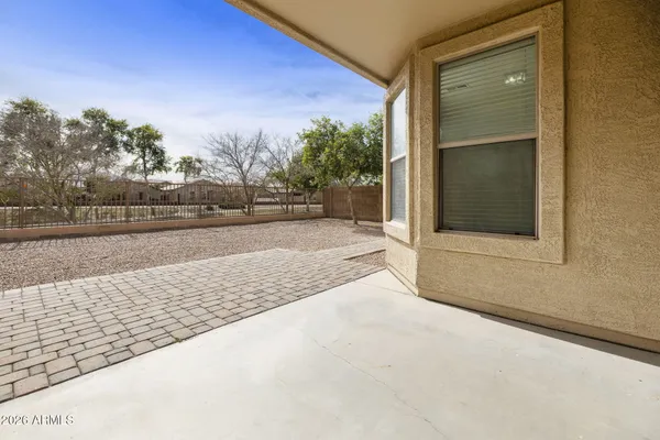 a view of swimming pool with outdoor seating and house in the background