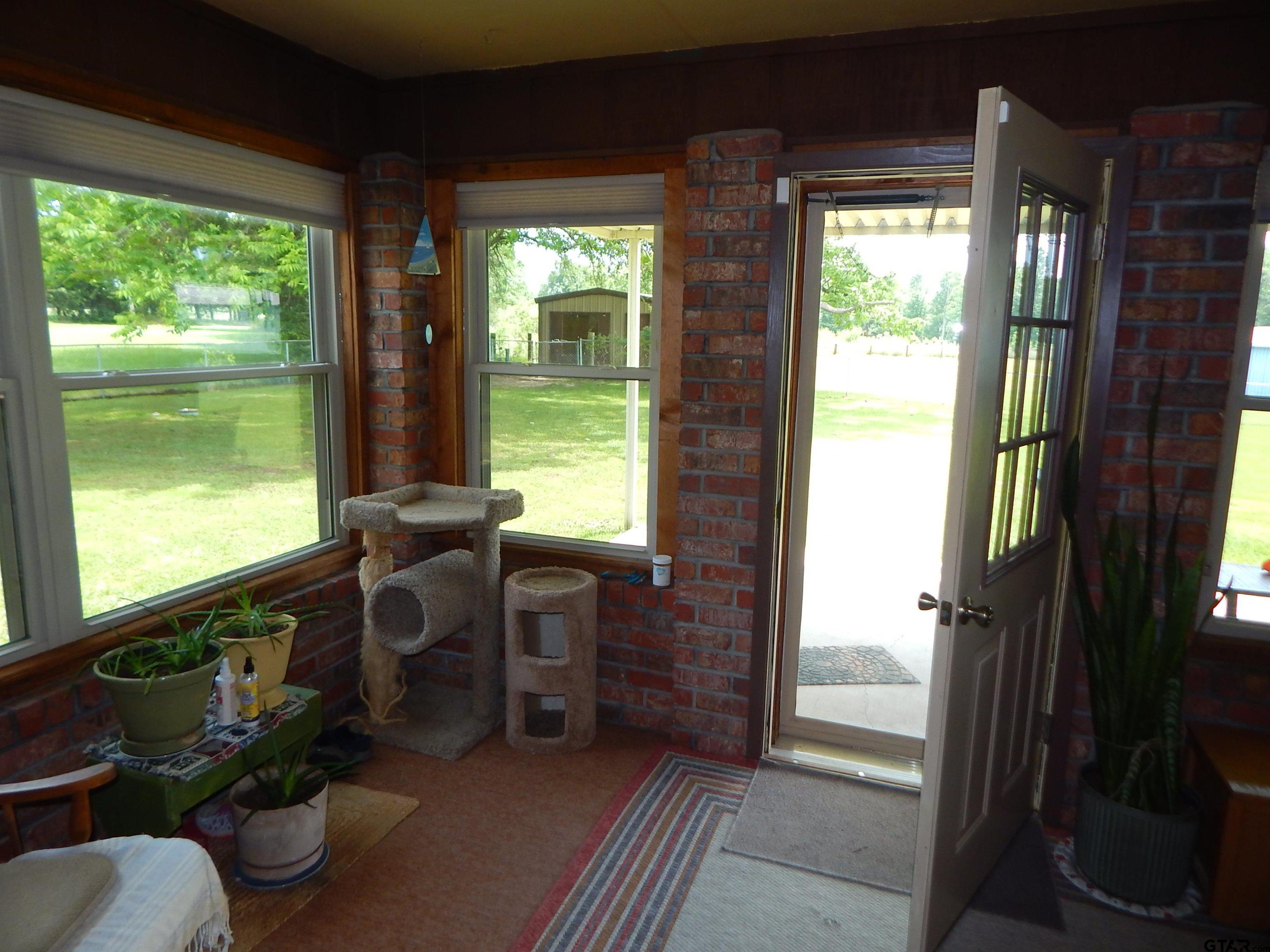 3035 Arrowwood Road Gilmer, TX 75644 - Photo 14 of 32 a room with furniture and a potted plant