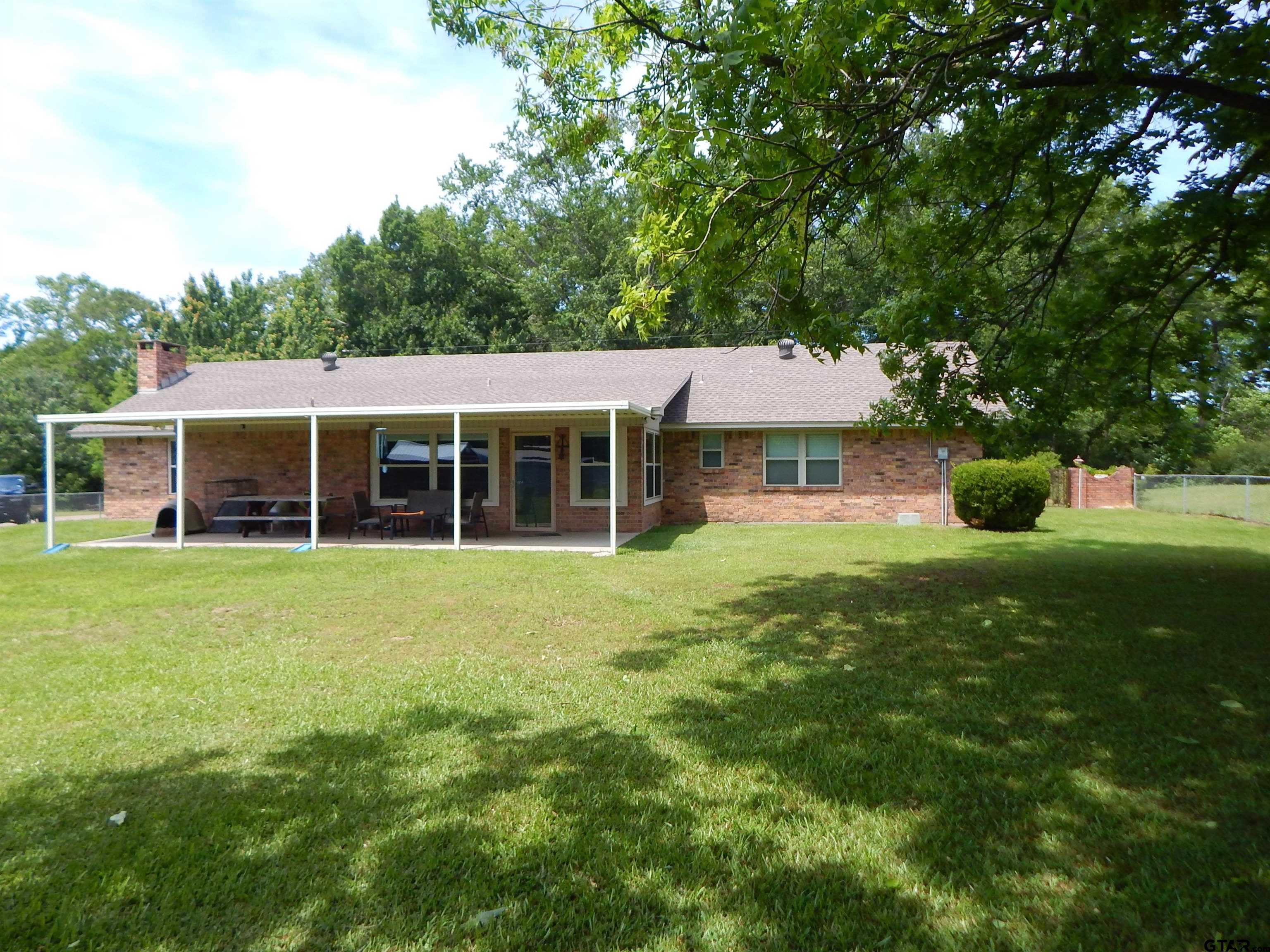 3035 Arrowwood Road Gilmer, TX 75644 - Photo 31 of 32 a front view of a house with a yard