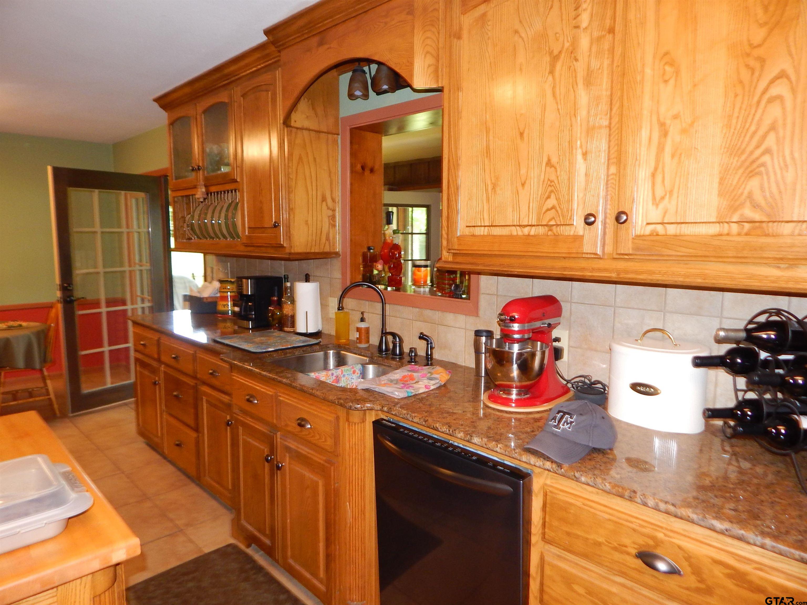 3035 Arrowwood Road Gilmer, TX 75644 - Photo 10 of 32 a kitchen with a sink and cabinets
