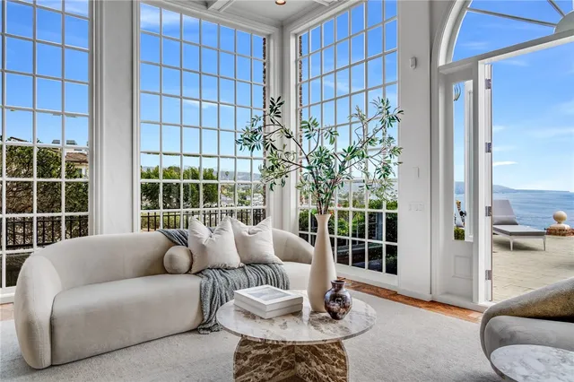 a bedroom with furniture and a large window