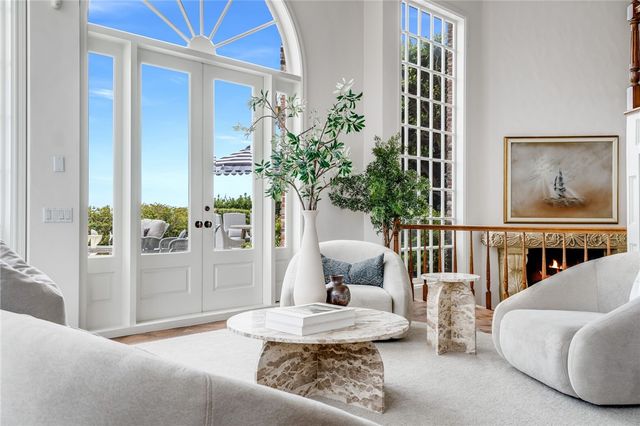 a living room with furniture a potted plant and a rug