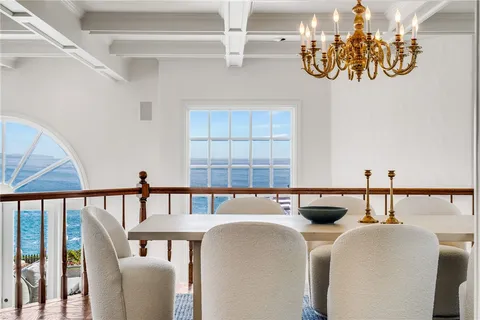 a view of an empty room with a cabinet and mirrors