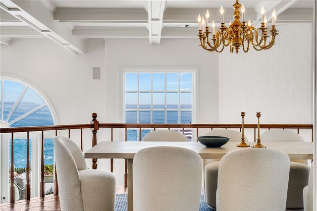 a view of an empty room with a cabinet and mirrors