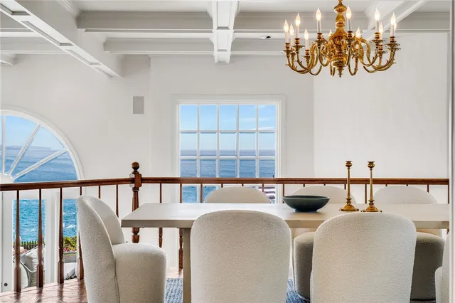 a view of an empty room with a cabinet and mirrors