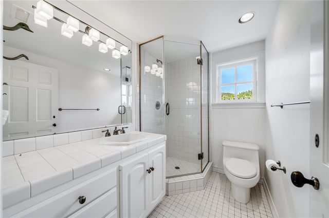 a living room with furniture a fireplace and a window