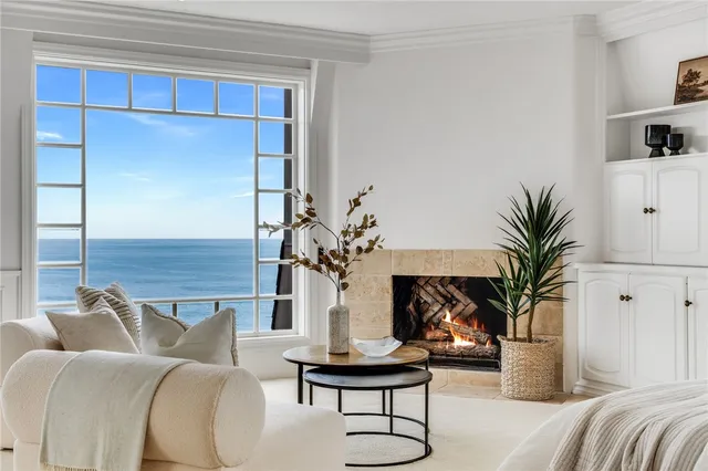 a bedroom with a bed a mirror and a potted plant