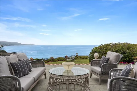 an aerial view of a house with a yard and a large tree