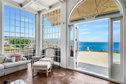 a living room with furniture a table and a potted plant
