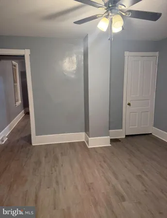 an empty room with wooden floor and door