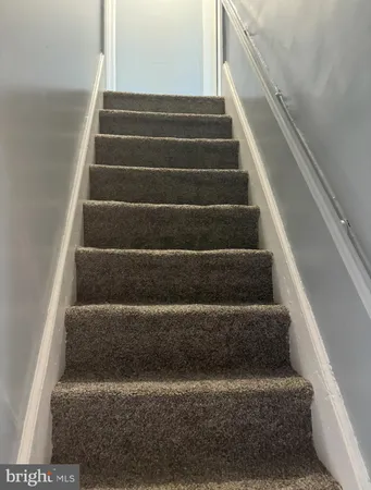 a view of staircase with white walls