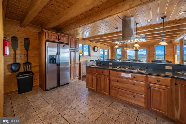 a view of a hallway with furniture and a window