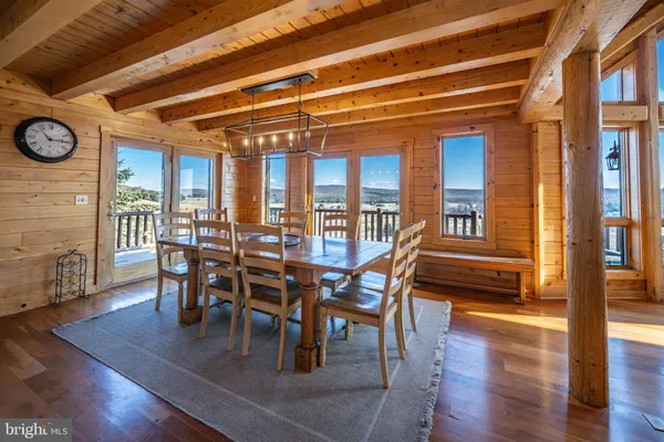 a spacious bedroom with a bed a table chair and a large window