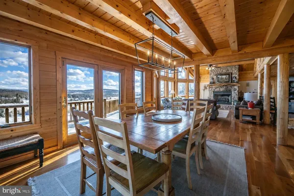 a bedroom with a large bed a flat tv screen and dresser