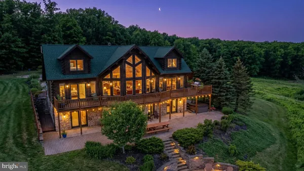 a living room with furniture a flat screen tv and a large window
