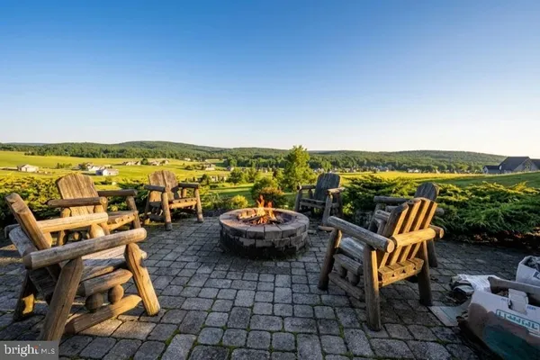 a living room with furniture a flat screen tv and a large window