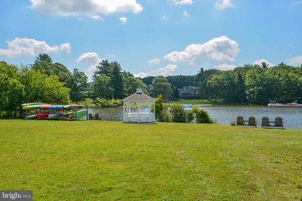 a view of a lake with lawn chairs