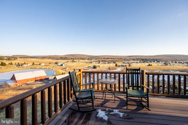 a spacious bedroom with a bed and wooden floor